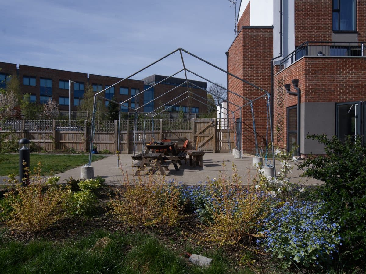 PLACEHOLDER (interim, pending final imagery): courtyard and picnic benches outside a Chapeltown Cohousing building